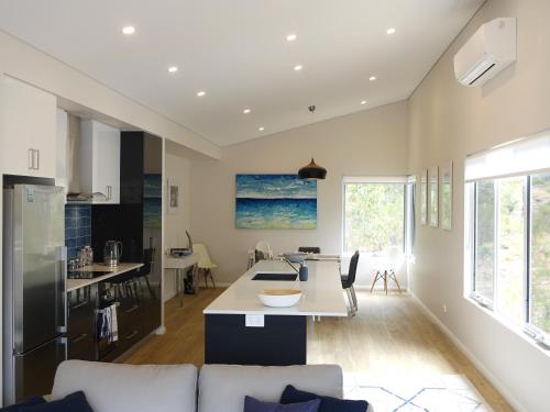 a kitchen and living room with a couch and a table at The Villa Dunsborough in Dunsborough
