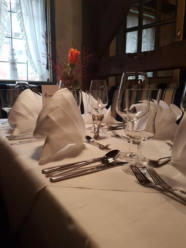 a table with a white table cloth and silverware on it at Faldernpoort in Emden