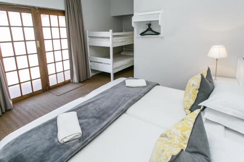 a bedroom with a large white bed in a room at Wagon Wheel Country Lodge in Beaufort West