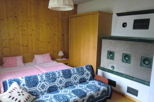 a bedroom with a bed and a couch at Ferienwohnung Ebner in Flattach