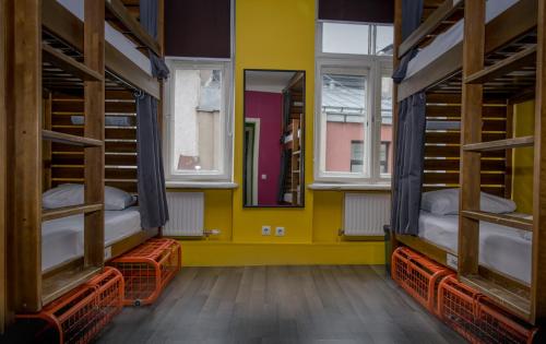 two bunk beds in a room with two windows at Naughty Squirrel Backpackers Hostel in Rīga