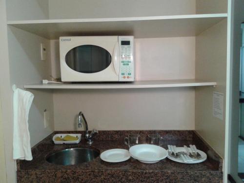 a microwave oven sitting on top of a kitchen counter at Hotel São Bento in Belo Horizonte