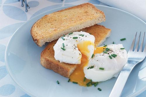 a plate with two eggs and toast on a table at Seaview John O Groats Hotel in John O Groats