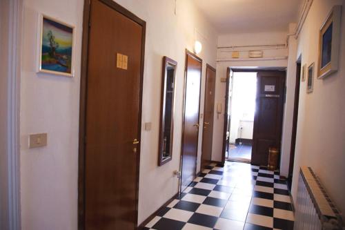 a hallway with a black and white checkered floor at Pensione Rittmeyer in Trieste