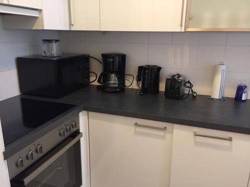 a kitchen counter with a coffee maker and a microwave at Apartments Opera in Vienna