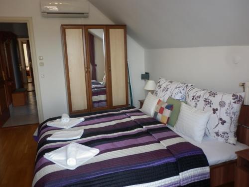 a hotel room with a bed with towels on it at Manor Villa in Hévíz