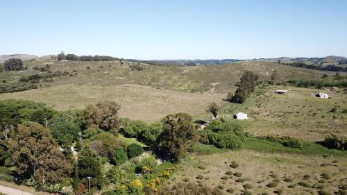 an overhead view of a field with trees and houses at Quinta El Monte in Tandil
