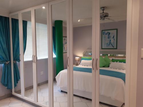 a bedroom with two beds and a large mirror at Boulevard 501 in Margate