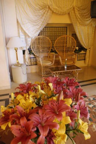 a bouquet of flowers sitting on top of a table at El Mouradi Hammamet in Hammamet