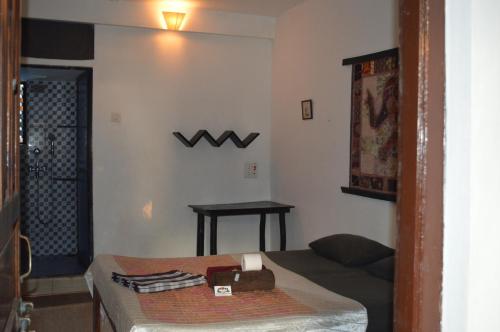 a room with a bed and a w sign on the wall at Cactus Guesthouse in Arambol