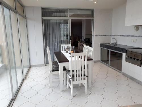 a kitchen with a table and chairs in a room at Boulevard 501 in Margate