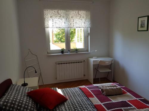 a bedroom with a bed and a window at Apartment 40 in Zagreb