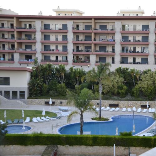 a hotel with a swimming pool and a resort at T1Encosta da Marina-Lagos in Lagos