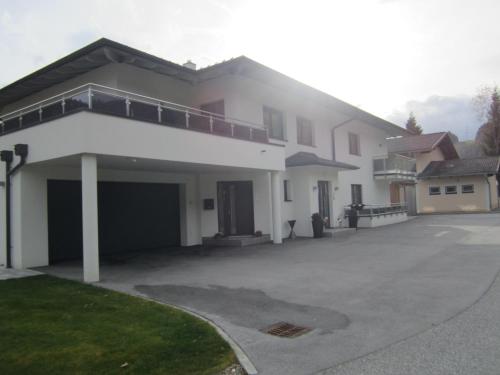 a large white house with a large driveway at Appartementhaus Gretzel in Wagrain