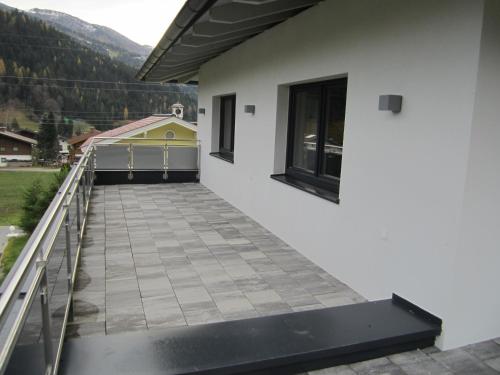 a balcony with a view of a house at Appartementhaus Gretzel in Wagrain