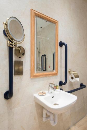a bathroom with a sink and a mirror at The George Street Hotel in Oxford