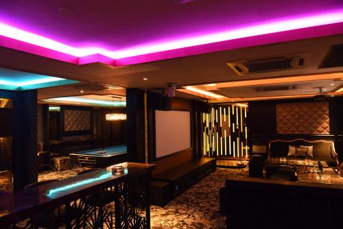 a room with a pool table and purple lights at Vangohh Eminent Hotel & Spa in Bukit Mertajam