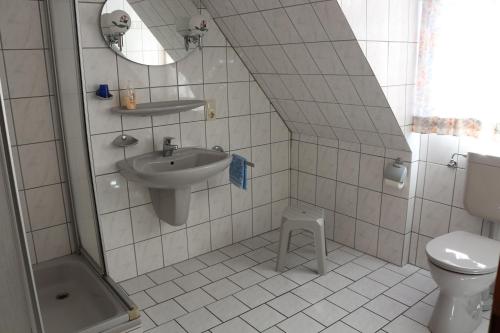 a bathroom with a sink and a toilet at Gaststätte Feldkamp in Hinte