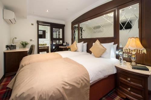 a bedroom with a large bed with a large window at The George Street Hotel in Oxford