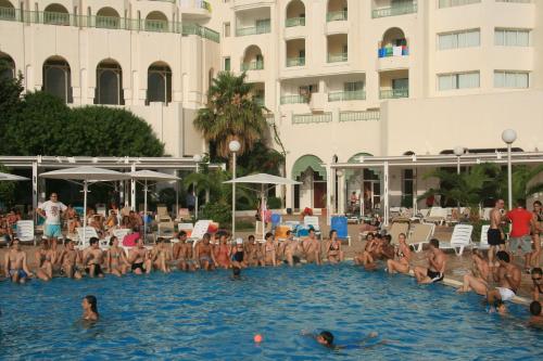 a group of people in the swimming pool at a hotel at El Mouradi Hammamet in Hammamet