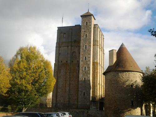 an old building with a tower on top of it at Les Calaubys in Huriel