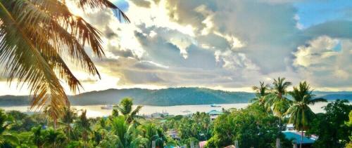 a painting of a view of a beach with palm trees at Ocean Terrace in Port Blair