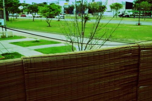 a wooden fence with a view of a park at B3 Apartments in Formosa
