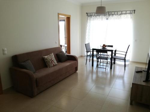 a living room with a couch and a table at T1Encosta da Marina-Lagos in Lagos