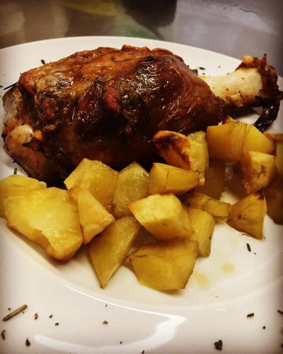 a plate of food with a piece of meat and potatoes at Agriturismo Nonna Du in Gavi