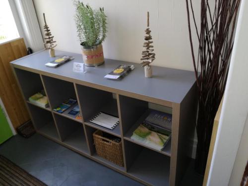 a table in a room with shelves at Driftwood B&B Weymouth in Weymouth