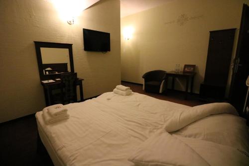 Ένα ή περισσότερα κρεβάτια σε δωμάτιο στο Hotel Marzanna