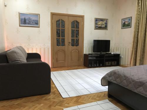 a living room with a couch and a television at Large apartment in the city center in Mukacheve