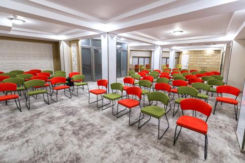 a room with chairs and red and green chairs at Prestige Boutique Hotel Craiova in Craiova