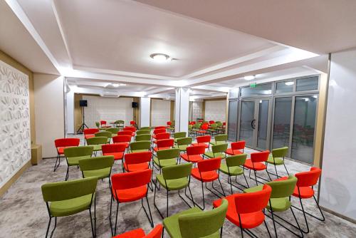 a room with green and red chairs at Prestige Boutique Hotel Craiova in Craiova