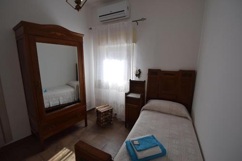 a bedroom with a bed and a dresser and a mirror at Zù Mariu B&B in Piazza Armerina