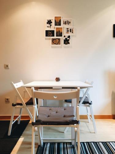 a table and chairs in a room with a desk at NEW APT center 1 min walk beach/river/casino!!! in Figueira da Foz
