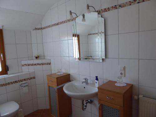 a bathroom with a sink and a mirror at Enzkreisspitze in Neuenbürg