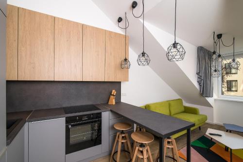 a kitchen with a black counter and a green chair at Smartflat & New apartment city center in Kaunas