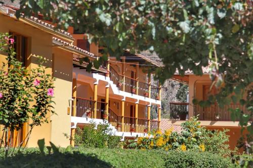 a building with balconies on the side of it at Tunupa Lodge Hotel in Ollantaytambo