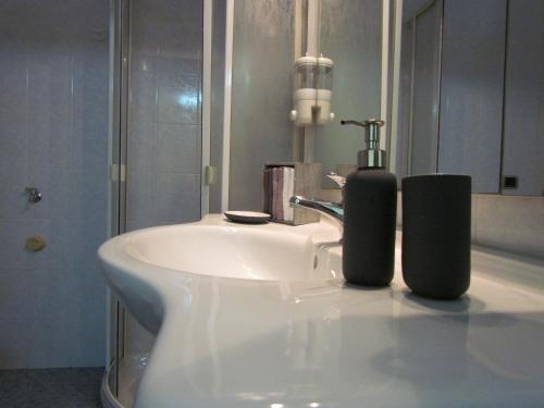 a bathroom with a white sink and a mirror at Al Nove e TreQuarti in Salerno