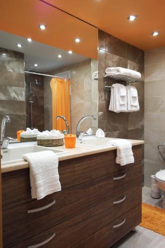 a bathroom with a sink and a tub and a mirror at Water House in Shumen