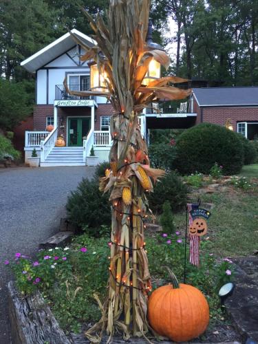 a tree with pumpkins in front of a house at Grafton Lodge in Lake Lure