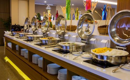 a buffet line with bowls and plates of food at The Nalod Da Nang in Da Nang