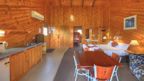a kitchen and a bedroom with a bed and a table at BIG4 Low Head Tourist Park in Low Head