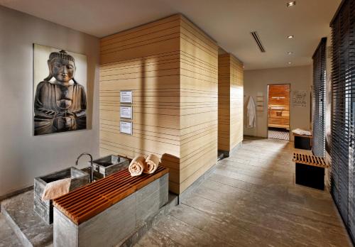 a bathroom with a large painting on the wall at Parkhotel Stuttgart Messe-Airport in Leinfelden-Echterdingen