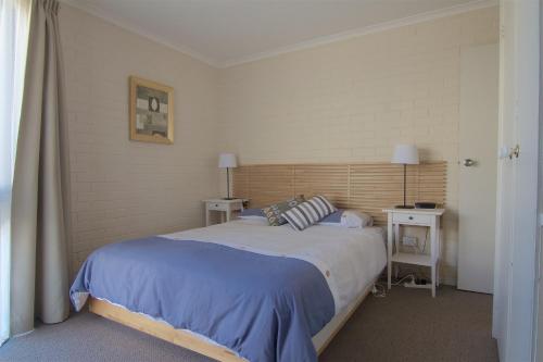 Ένα ή περισσότερα κρεβάτια σε δωμάτιο στο The Sands Holiday Apartments