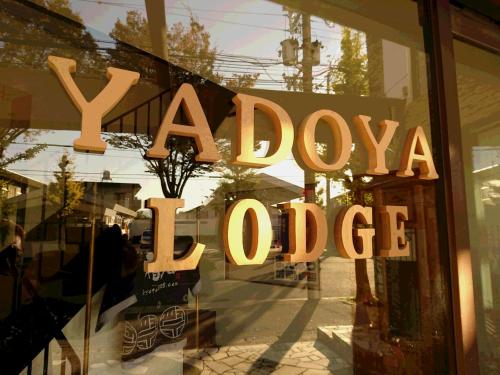 a shop window with a xiaoda new office sign at Yadoya Lodge in Kyoto