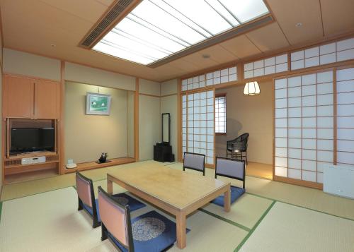 a dining room with a table and chairs and a skylight at Takarazuka Washington Hotel in Takarazuka