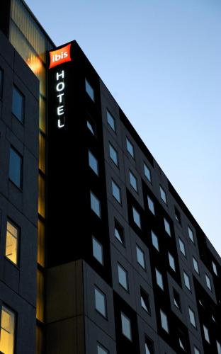 a black building with a hotel sign on it at ibis Amsterdam City West in Amsterdam