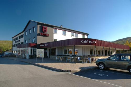 a car parked in a parking lot in front of a building at Hamarøy Hotel in Innhavet
